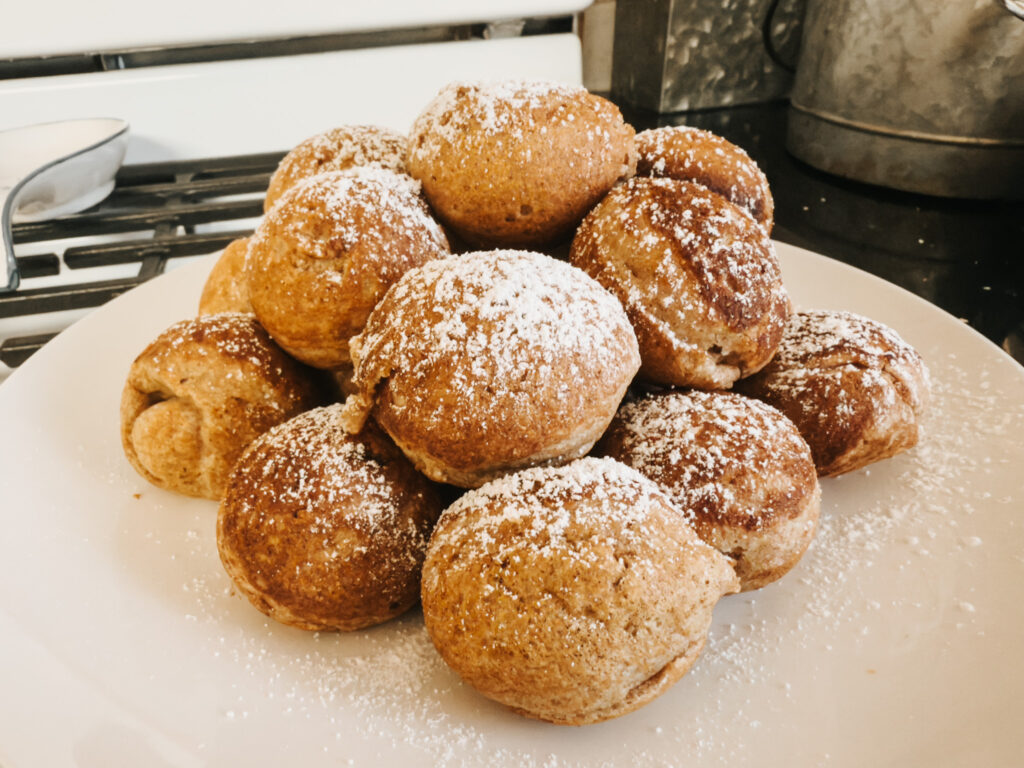 Fresh milled aebleskivers sprinkled with powdered sugar